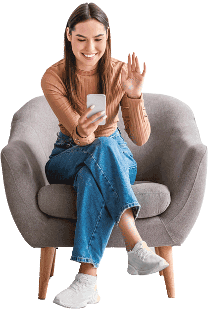 Woman using phone for online ADHD assessment, smiling and waving while seated in chair