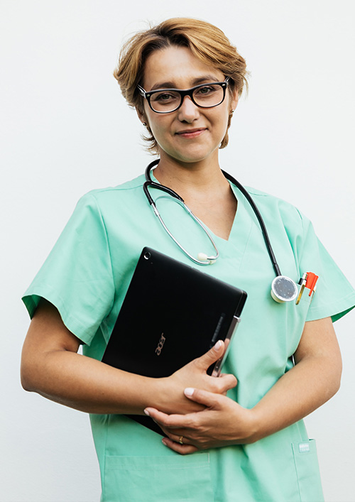 Licensed healthcare professional holding a tablet, wearing scrubs and a stethoscope