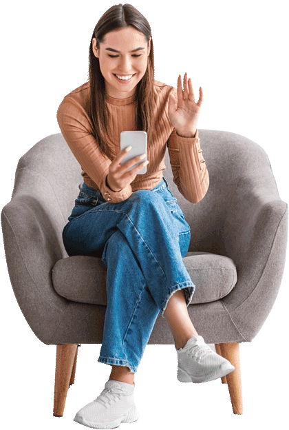 Woman using phone for online ADHD assessment, smiling and waving while seated in chair