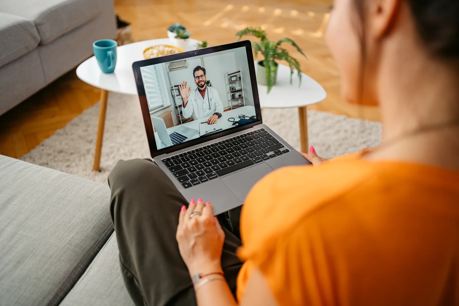 Adult having a virtual ADHD assessment with a clinician on a laptop video call at home in Canada