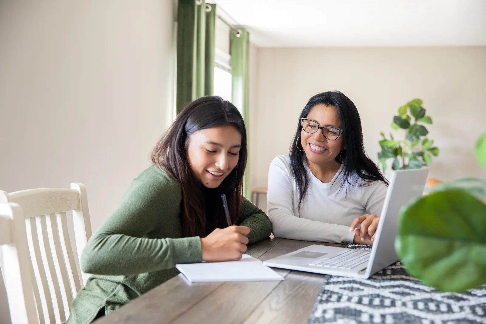 Teenager and parent together at a laptop during an online ADHD assessment for youth