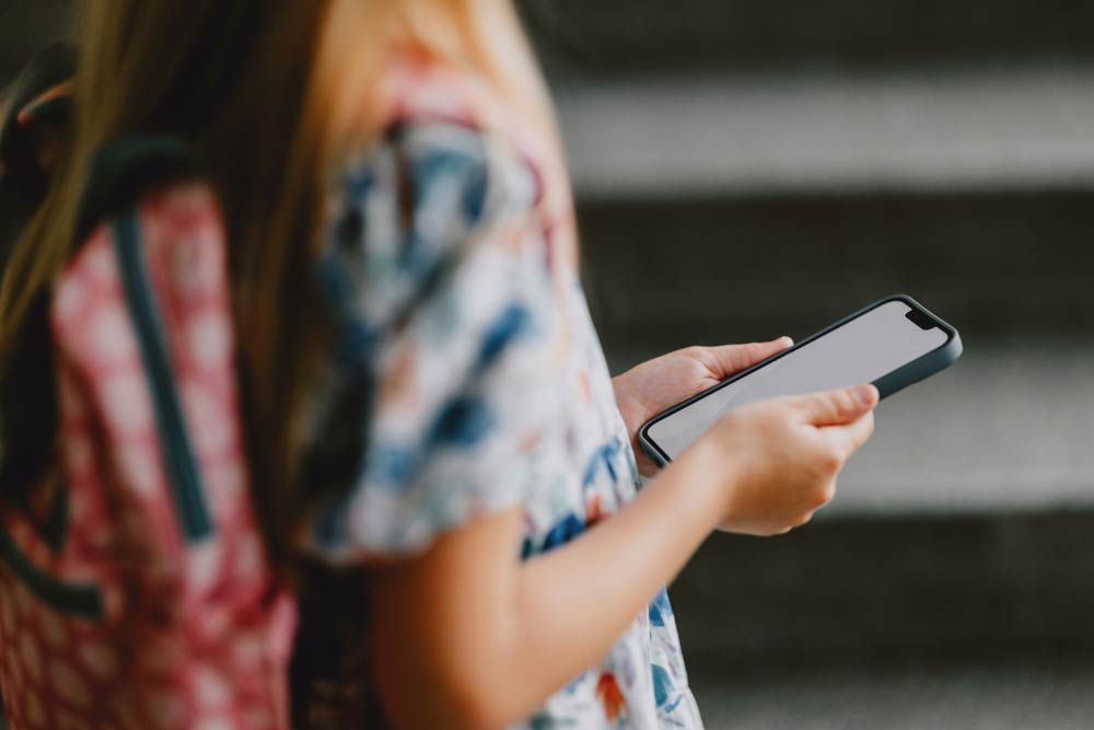 Teen with ADHD using smartphone outdoors, screen time and technology distractions