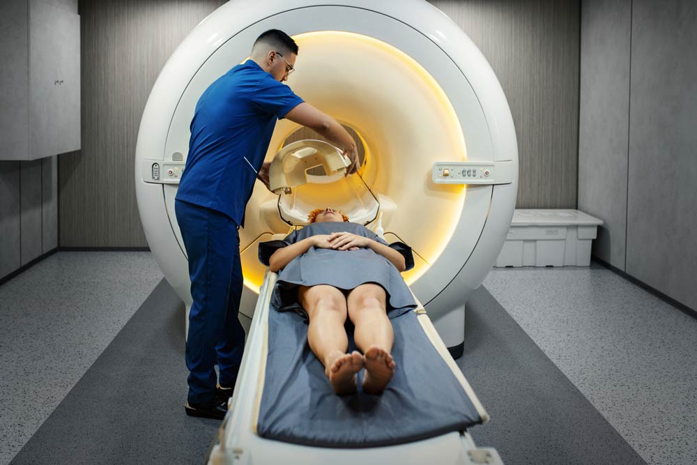 Technician preparing a patient for an MRI scan, representing brain imaging research revealing structural and functional differences in ADHD.