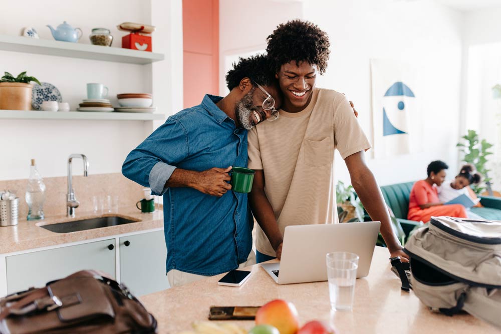 A family shares a warm moment in the kitchen while discussing together, symbolizing trust, support, and connection in families raising teens with ADHD.
