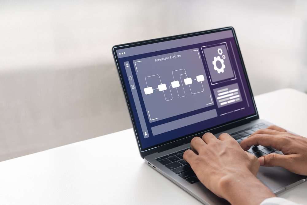 Open laptop with a clean desktop and a single window beside a notebook