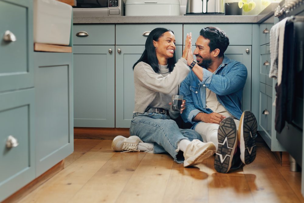 Couple at a kitchen table on a Sunday evening with a notebook and two mugs