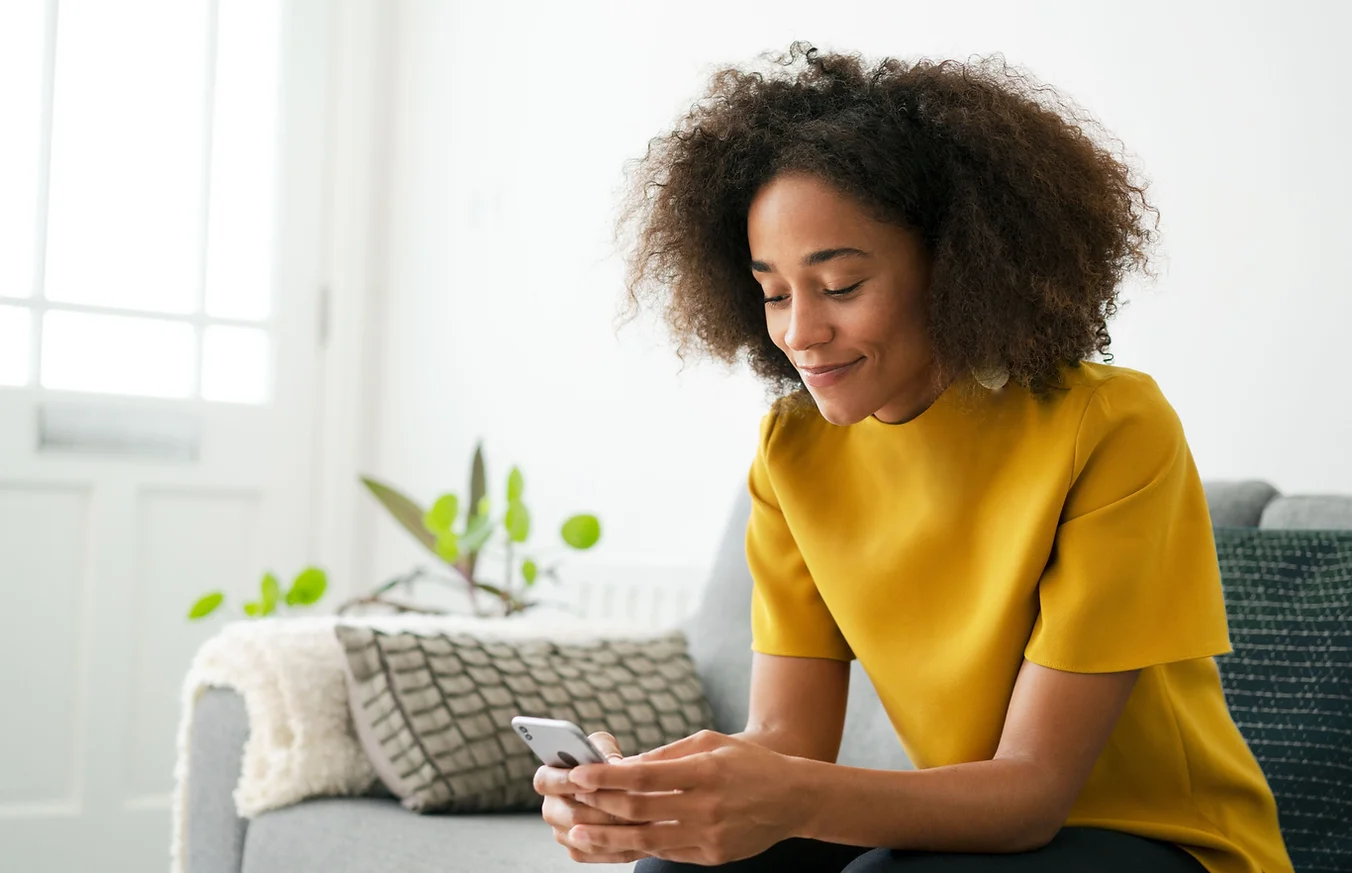 Woman using a smartphone to start an online ADHD self-assessment