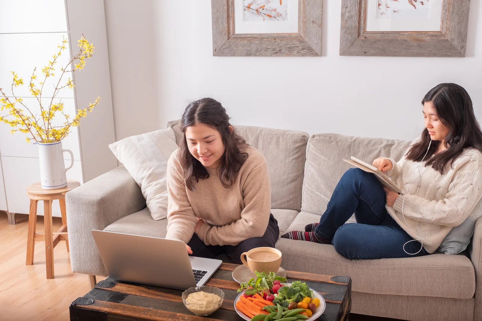 A woman settles in by a rainy Vancouver window with her laptop for a virtual ADHD assessment